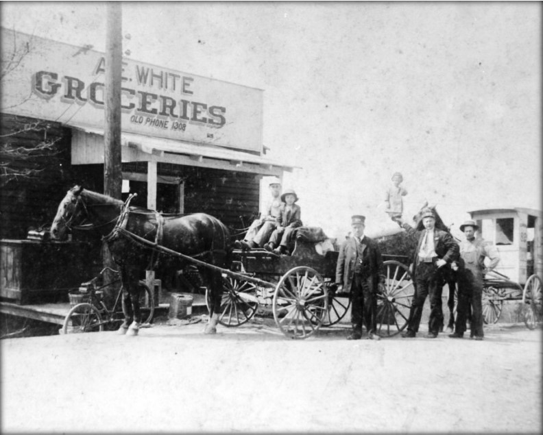 A.E. White Groceries, circa 1915. To the right is a Island Home Dairy truck. (McClung Historical Collection)